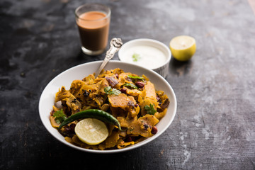 Homemade Kothu Parotta/ Paratha or Stir Fried Leftover Chapati Masala or  fodnichi poli in marathi, served in a bowl or plate with curd and hot tea. Selective focus