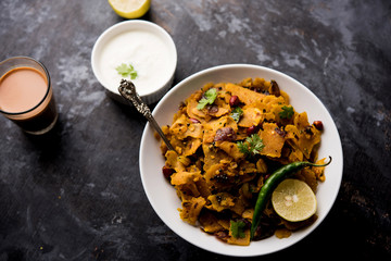 Homemade Kothu Parotta/ Paratha or Stir Fried Leftover Chapati Masala or  fodnichi poli in marathi, served in a bowl or plate with curd and hot tea. Selective focus
