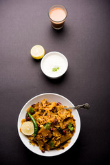 Homemade Kothu Parotta/ Paratha or Stir Fried Leftover Chapati Masala or  fodnichi poli in marathi, served in a bowl or plate with curd and hot tea. Selective focus