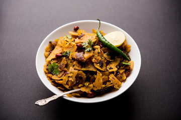 Homemade Kothu Parotta/ Paratha or Stir Fried Leftover Chapati Masala or  fodnichi poli in marathi, served in a bowl or plate with curd and hot tea. Selective focus