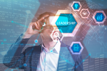 Business, Technology, Internet and network concept. Young businessman working in virtual reality glasses sees the inscription: leadership