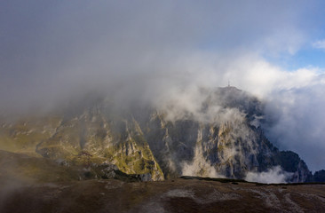 Carpathian Mountains peaks on a foggy autumn morning. Bucegi Mountains, Romania