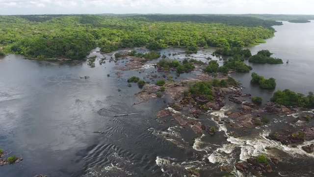 Motorised canoe going up rapids in saut Maripa French Guiana Brazil Aerial drone
