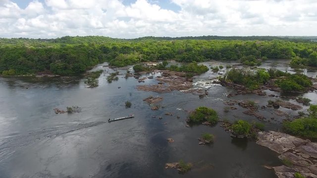 Motorised canoe arriving in rapids in saut Maripa French Guiana Brazil 