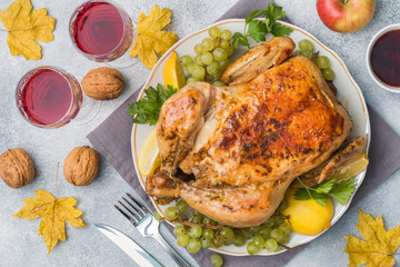 Baked chicken, mashed potatoes and wine glasses for dinner on the festive table.