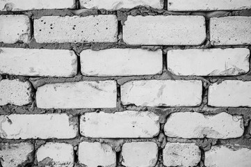 Brick walls background with a concrete texture between stones. Renovation and repair works of the building house.