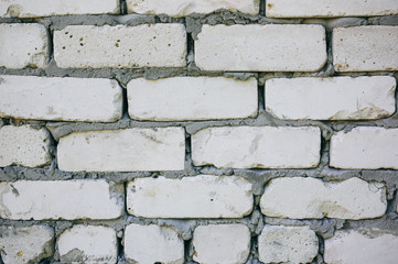 Brick walls background with a concrete texture between stones. Renovation and repair works of the building house.