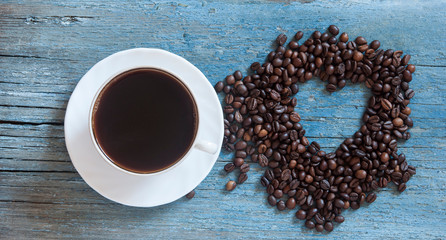 Coffee beans in heart shape on wood table