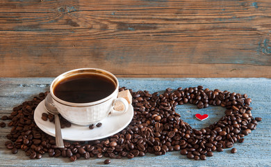 Coffee beans in heart shape on wood table