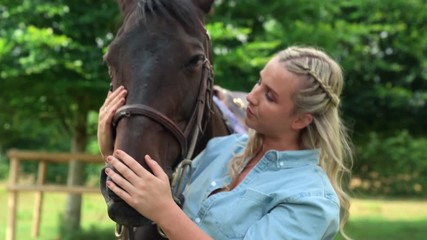 Woman stroking horse