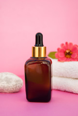 Fototapeta na wymiar Beauty spa cosmetics, salon therapy concept. Glass bottle on pink background.