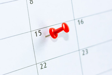 15 date pinning on calendar with Red color pin thumbtack. Save the Date concept.