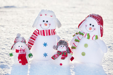 Family snowman on snow