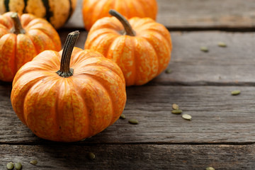 Autumn Pumpkin Thanksgiving Background - orange pumpkins over wooden table