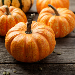 Autumn Pumpkin Thanksgiving Background - orange pumpkins over wooden table