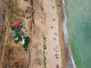 People rest on the wild beach with their families.