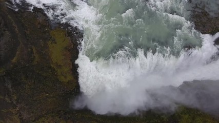 Aerial drone shot flying over Gulfoss waterfall in Iceland. Cloudy day, vertical top view, medium altitude flight - Powered by Adobe