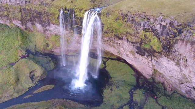 Aerial drone shot of Seljalandsfoss waterfall in south Iceland a beautiful waterfall that you can walk behind. medium altitude flight