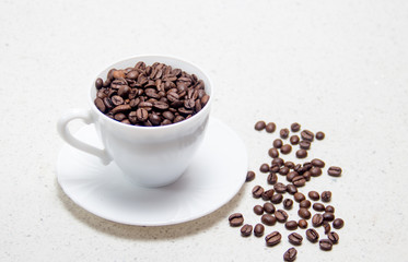 Preparation of coffee. Coffee beans in a white Cup.