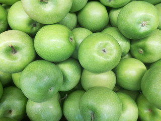 the background of the sale of green apples in the local market. more apples