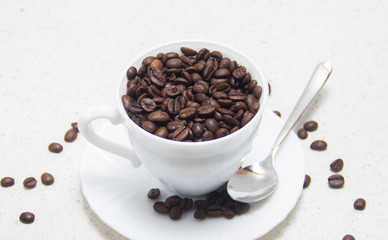 Coffee beans in a white Cup. Preparation of coffee.
