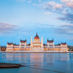 Fototapeta na wymiar Parliament building in Budapest, Hungary. Building facade with reflection in water. Beautiful picture at sunset