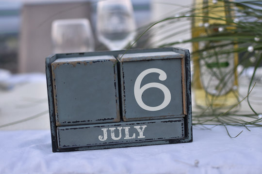 Wood blocks in box with date, day and month 6 July. Wooden blocks calendar