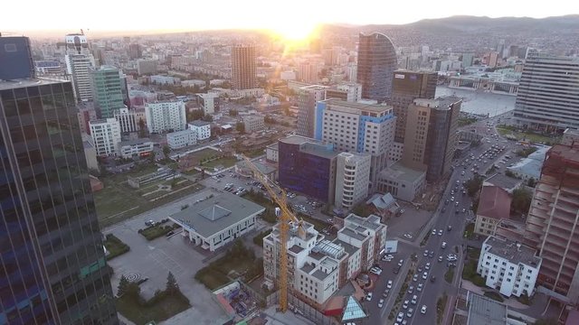 Aerial drone shot of building capital Mongolia facing sunset 