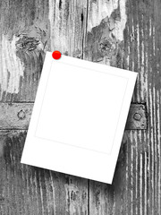 Blank square instant photo frame on grey weathered wooden window detail