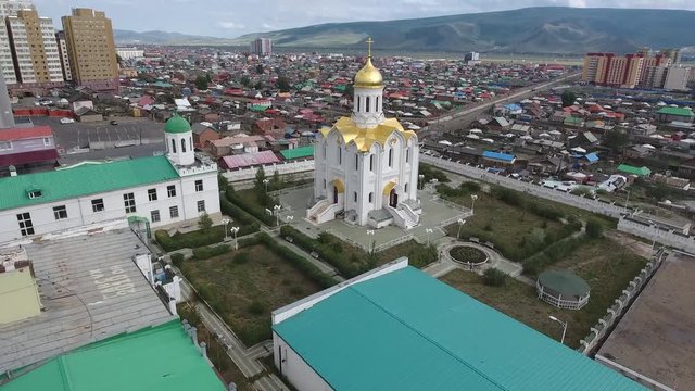 Aerial drone shot of a russian church with gold plated roof in mongolia
