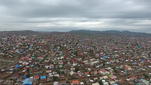 Aerial drone shot of poor suburbs in Mongolia Ulan Bator. Endless yurts cloudy 
