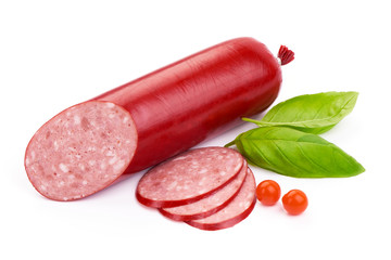 Italian smoked Salami sausage with slices and basil leaves, close-up, isolated on a white background
