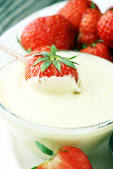 Fondue with Melting chocolate or melted chocolate and strawberry.