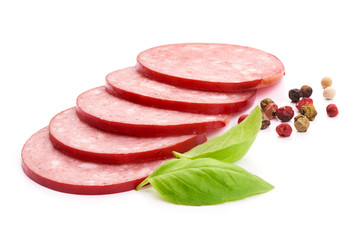 Thinly sliced Italian smoked Salami sausage with basil leaves, close-up, isolated on a white background.