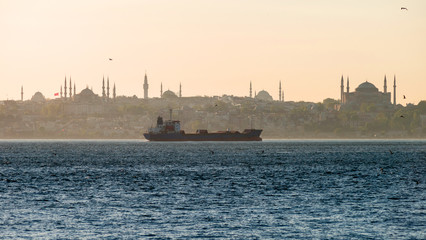 Evening on the Bosphorus. A cargo ship against the background of the Sultan Ahmed district.