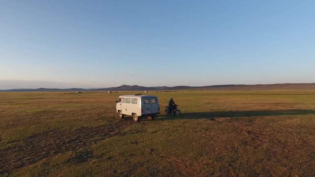 Flying around a van and dirt bike in Mongolia. Steppes early morning