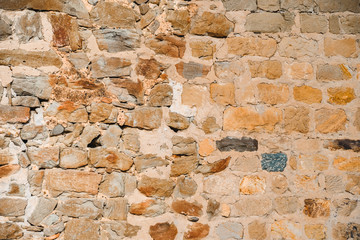 Ancient wall from big colourful brick stones