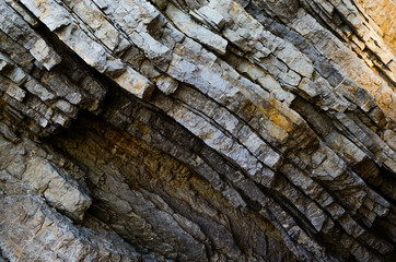 Rock, the background of the layers of ancient sediments.