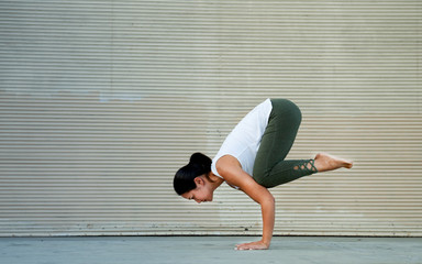 Outdoor Fitness Female Yoga Instructor in Crow Pose