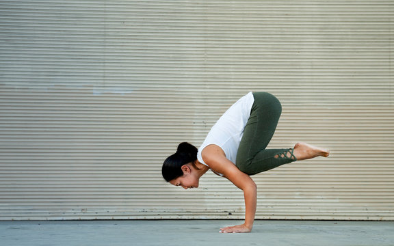 Outdoor Fitness Female Yoga Instructor in Crow Pose