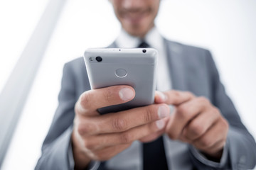 Businessman looking at mobile phone in office