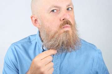 portrait of a bearded man on a light background