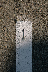 Old vintage brass door Key on asphalt road