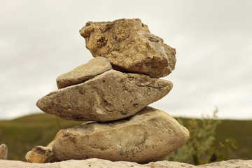 Balanced stones on the alpine meadow near caucasus mountains