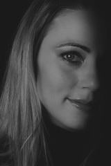 Fototapeta premium Beautiful woman emotional portrait in low light artistic conversion