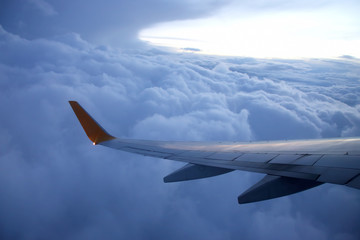 The wing of an airplane above the clouds