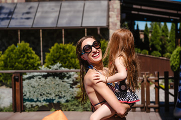 Mom holds her daughter in her arms