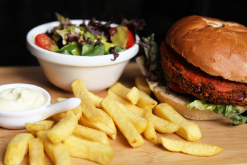 Vegan burger with salad, and french fries