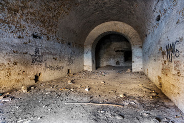 Old abandoned tunnel in the underground wine cellar. Entrance to the catacombs in Odessa, Ukraine. As a creative background for staged dark design