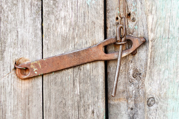 Old antique iron lock, deadbolt, bolt on the door is not painted close-up.